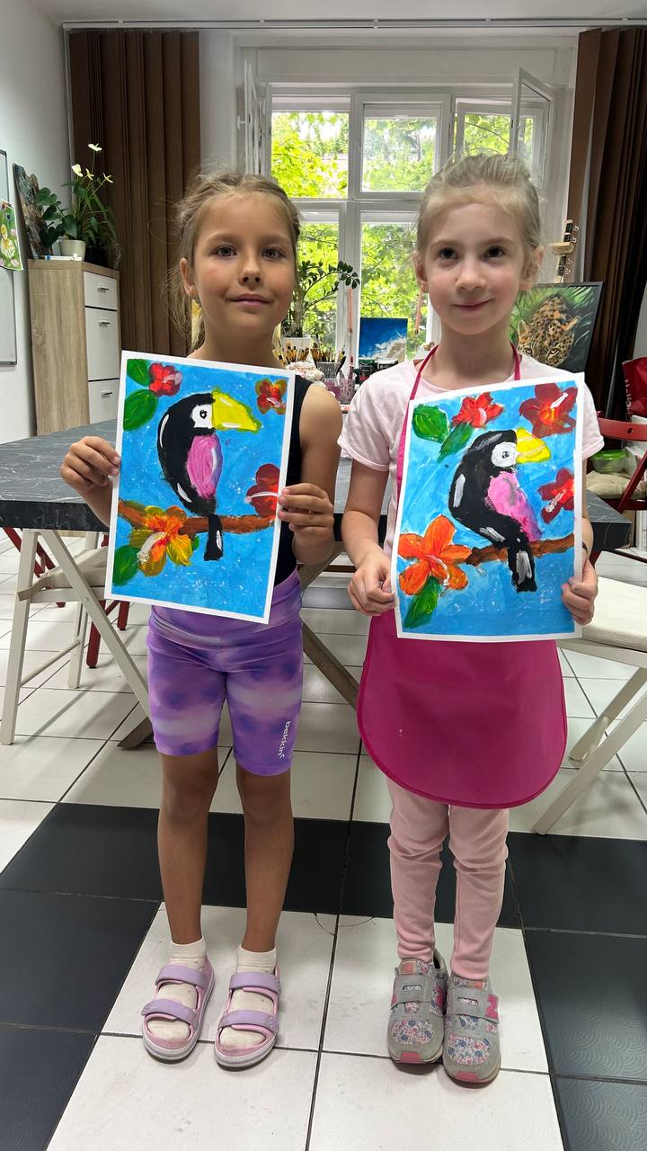 Two girls with their toucan paintings